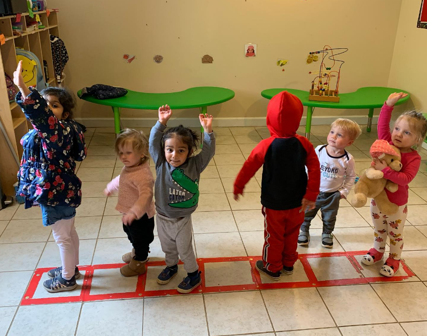 kids standing in line playing a game