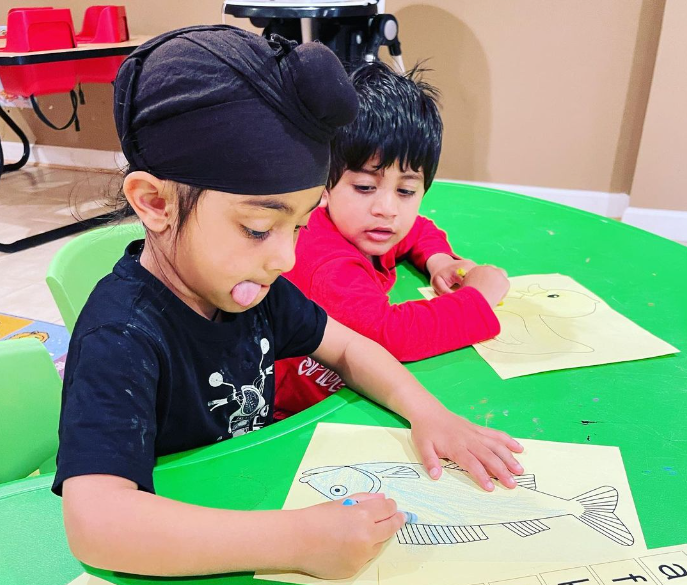 kid drawing on a paper