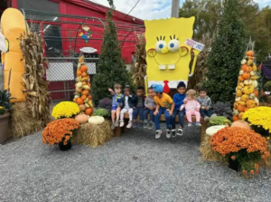 Kids from busy minds daycare in a hay field