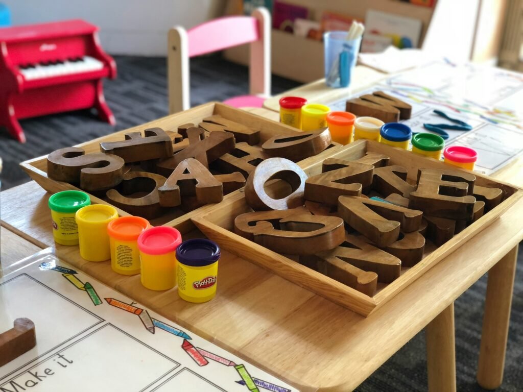 a tray with a bunch of wooden alphabets